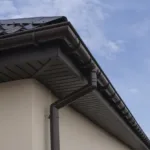 Brown plastic rain gutter system on a house