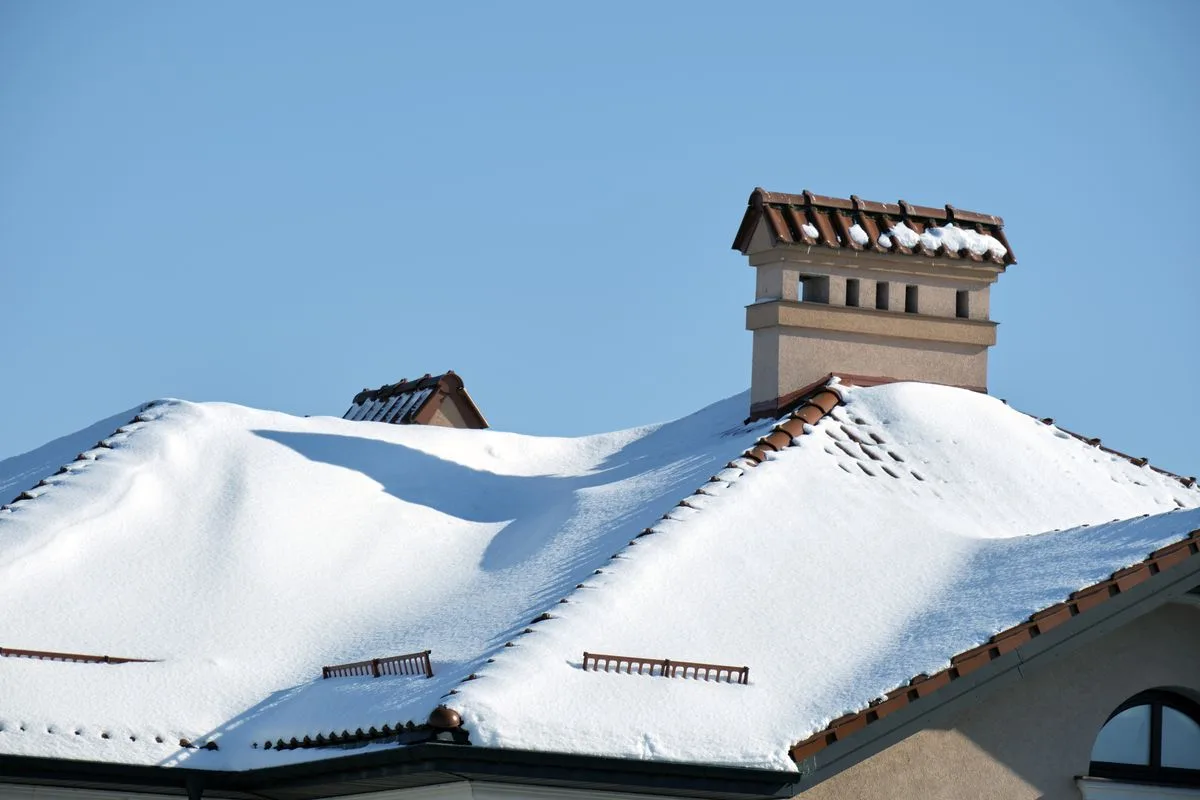 Snow-covered roof showing depth of snow on home